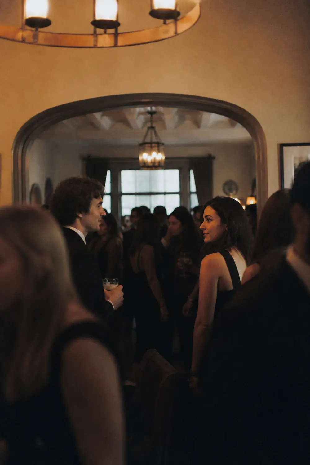 Two people exchanging a look across a crowded interior