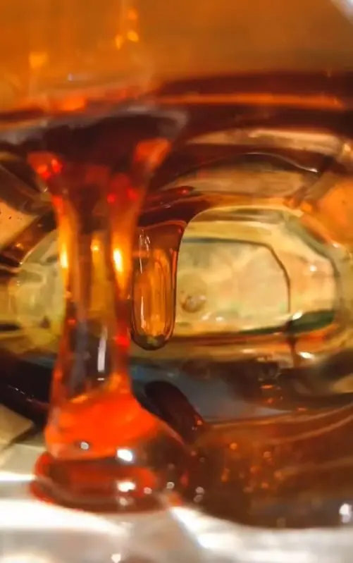 Close-up of amber juice being poured, from the JahaJuice brand